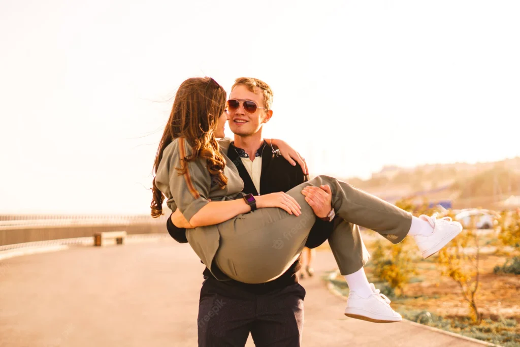young man holding carrying his young girlfriend street hugs having fun couple 63762 4286