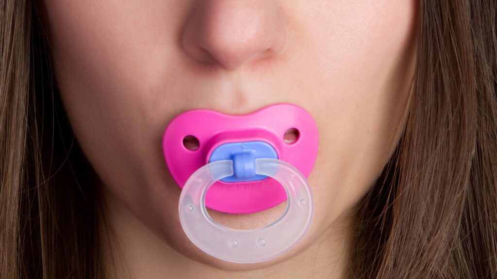 181116093626 woman with pacifier in mouth stock