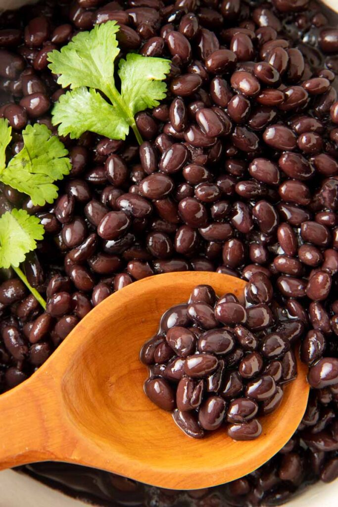 seasoned black beans on spoon